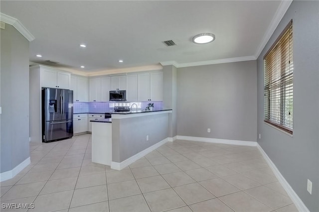 1654 Double Eagle Trl, Naples, FL 34120 - kitchen with stainless steel appliances, ornamental molding, tasteful backsplash, white cabinets, and light tile patterned floors