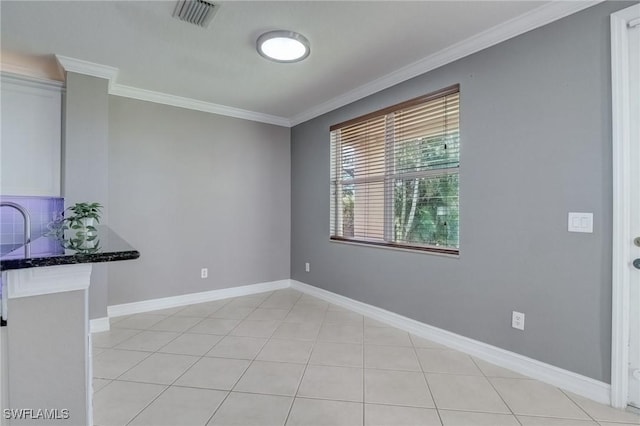 tiled spare room with crown molding