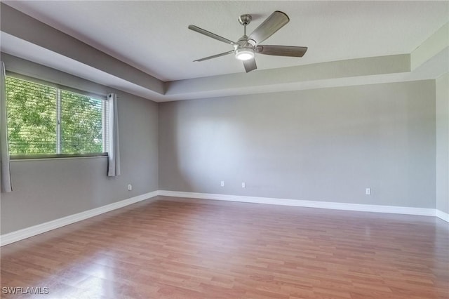 spare room featuring light hardwood / wood-style flooring and ceiling fan