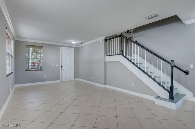 interior space featuring ornamental molding and light tile patterned floors