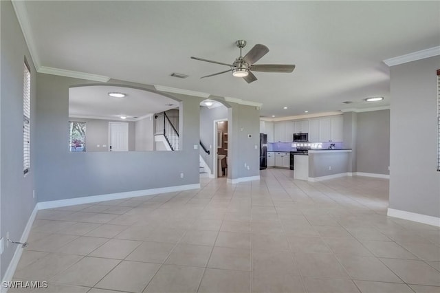 unfurnished living room featuring light tile patterned floors, ornamental molding, and ceiling fan