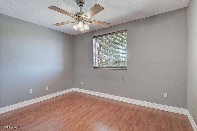 spare room featuring hardwood / wood-style floors and ceiling fan