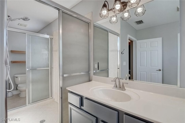 bathroom featuring walk in shower, tile patterned floors, toilet, and vanity