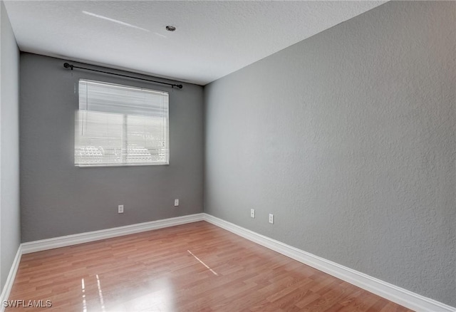 unfurnished room featuring hardwood / wood-style floors