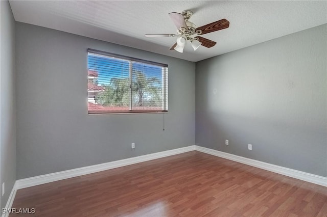 empty room featuring a textured ceiling, wood-type flooring, and ceiling fan