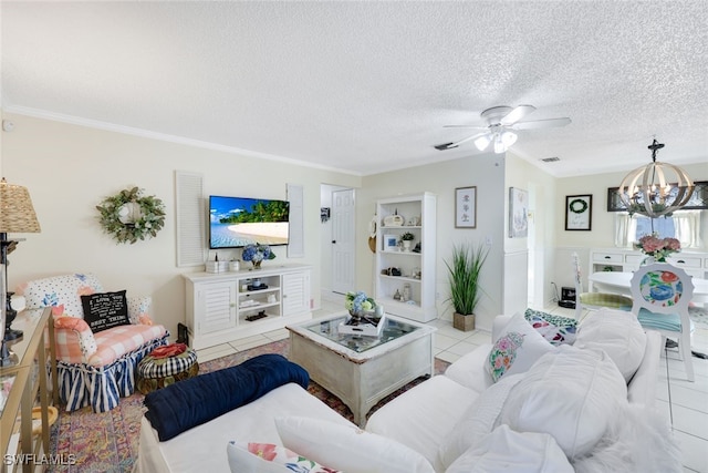 living room featuring light tile patterned flooring, ornamental molding, an inviting chandelier, and a textured ceiling