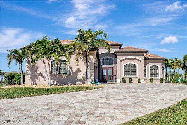 mediterranean / spanish-style home with french doors