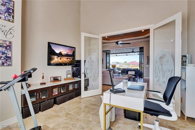 office area with ceiling fan, ornamental molding, french doors, and a raised ceiling