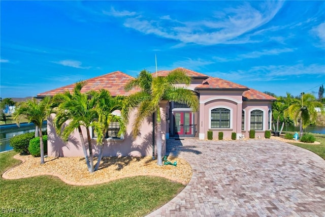 mediterranean / spanish-style home featuring french doors