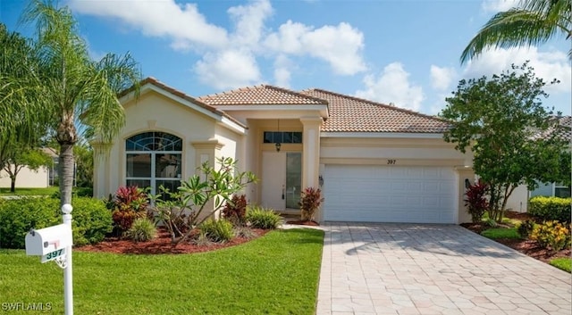 mediterranean / spanish house with a garage and a front lawn