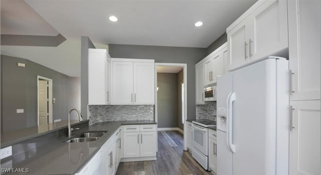 kitchen featuring dark wood-type flooring, sink, tasteful backsplash, white appliances, and white cabinets