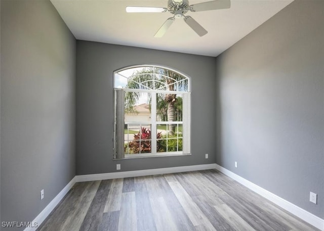 unfurnished room with hardwood / wood-style floors and ceiling fan