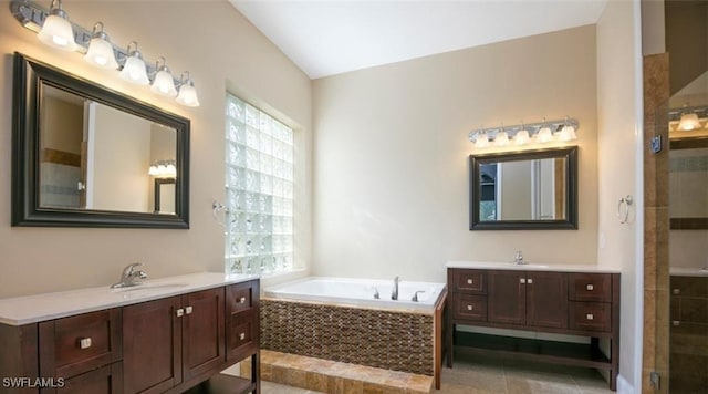 bathroom with tile patterned floors, plenty of natural light, shower with separate bathtub, and vanity