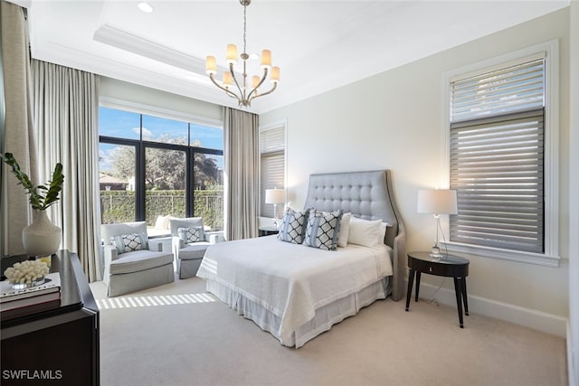 bedroom with crown molding, carpet floors, an inviting chandelier, and a tray ceiling