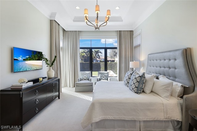 bedroom with ornamental molding, a tray ceiling, carpet, and a notable chandelier