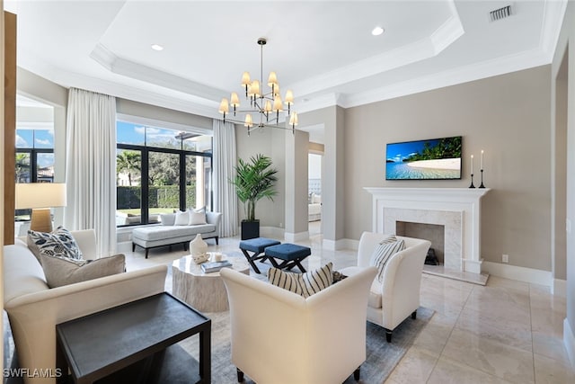 living room with a raised ceiling, crown molding, and a fireplace