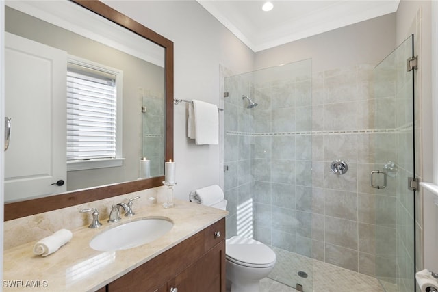 bathroom featuring an enclosed shower, crown molding, vanity, and toilet