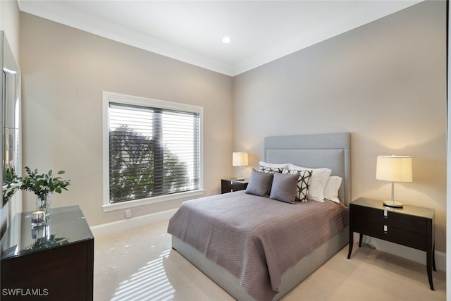 bedroom featuring ornamental molding and light carpet