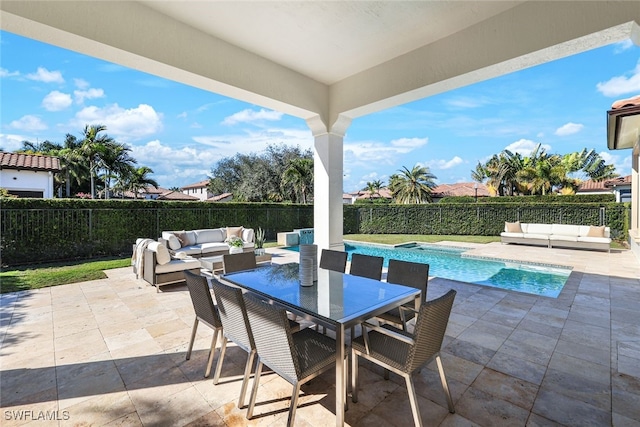 view of patio with a fenced in pool and outdoor lounge area