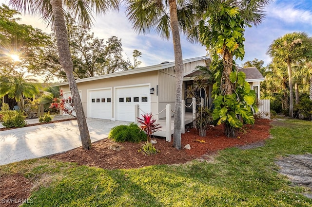 view of front of home featuring a garage and a front lawn