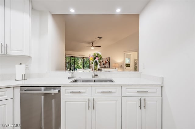 kitchen featuring lofted ceiling, sink, dishwasher, ceiling fan, and white cabinets