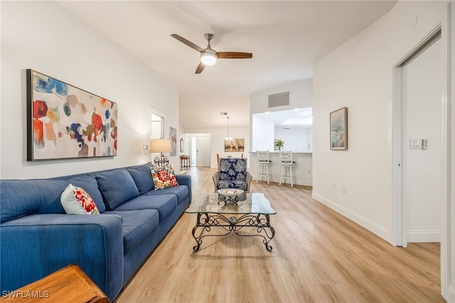 living room with hardwood / wood-style flooring and ceiling fan