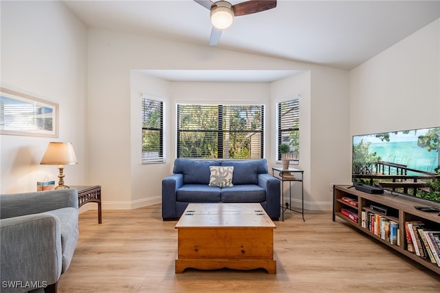 living room with ceiling fan, lofted ceiling, and light wood-type flooring