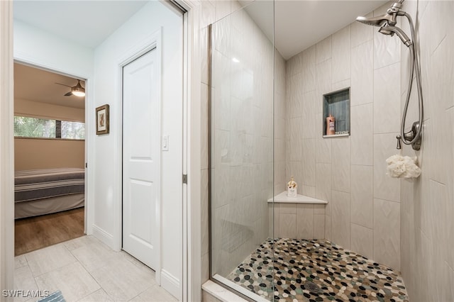 bathroom with ceiling fan, tiled shower, and tile patterned floors