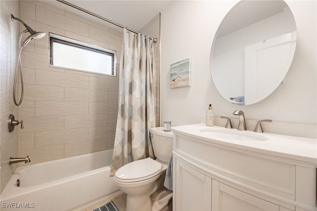 full bathroom with vanity, shower / tub combo with curtain, and toilet