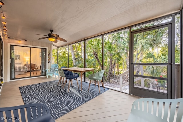 sunroom / solarium with ceiling fan and a wealth of natural light