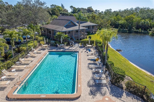 view of swimming pool with a water view and a patio area