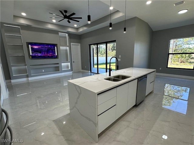 kitchen with white cabinetry, dishwasher, a kitchen island with sink, and light stone counters