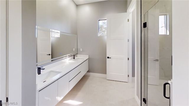 bathroom with a shower with door and vanity