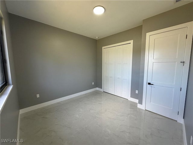 unfurnished bedroom featuring a closet