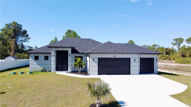 view of front of house with a garage and a front yard