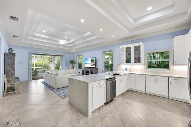 kitchen featuring sink, dishwasher, a raised ceiling, and white cabinets