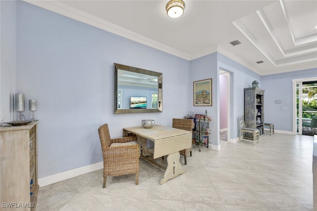 dining room with ornamental molding and a tray ceiling