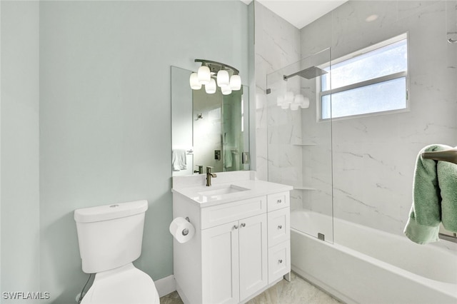 full bathroom featuring vanity, tiled shower / bath, and toilet