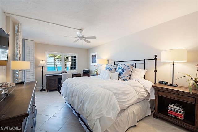 tiled bedroom with ceiling fan