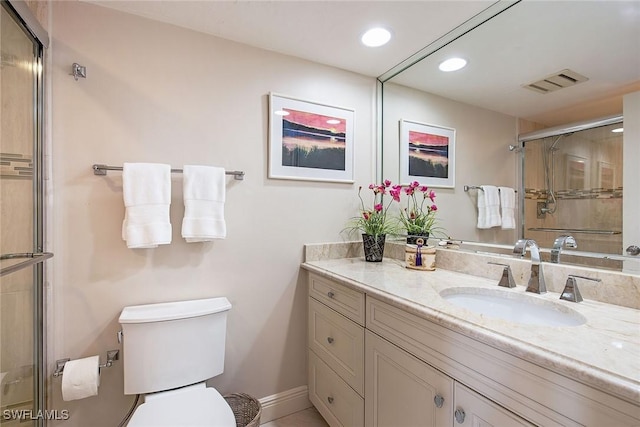 bathroom featuring walk in shower, vanity, and toilet