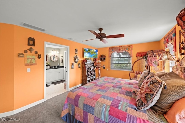 carpeted bedroom featuring ensuite bath and ceiling fan