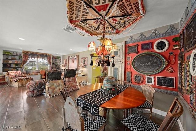 tiled dining room featuring a chandelier