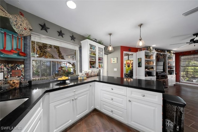 kitchen with white cabinetry, ceiling fan, decorative light fixtures, and kitchen peninsula