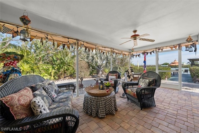 sunroom featuring ceiling fan