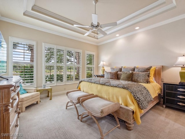 carpeted bedroom featuring crown molding, a raised ceiling, and ceiling fan