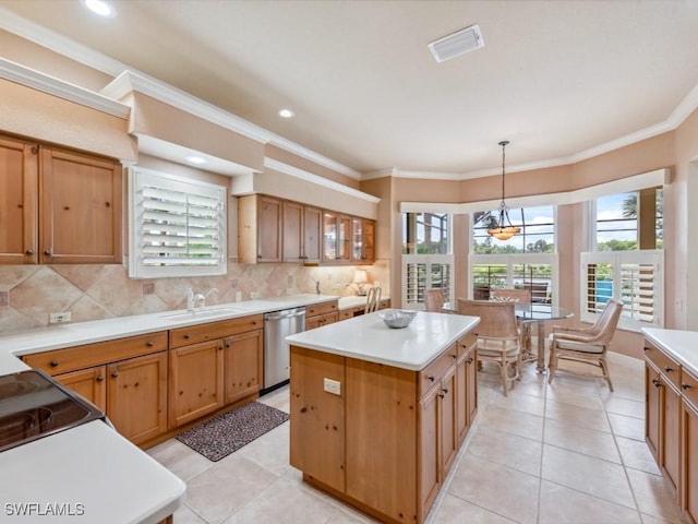 kitchen with a kitchen island, tasteful backsplash, sink, hanging light fixtures, and stainless steel dishwasher