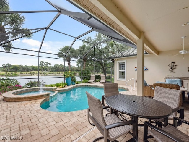 view of pool featuring a patio, an in ground hot tub, ceiling fan, glass enclosure, and a water view