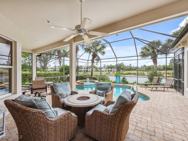 view of patio featuring a water view, a swimming pool with hot tub, a lanai, and a fire pit