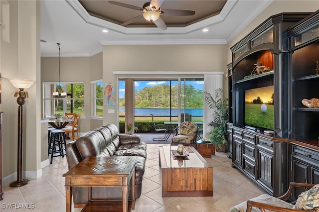 tiled living room with a raised ceiling, crown molding, a high ceiling, and ceiling fan with notable chandelier