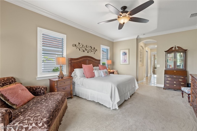 carpeted bedroom with ornamental molding and ceiling fan